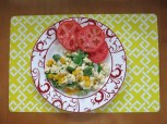 scrambled eggs and fiddle heads with peppers, onions and tomatoe